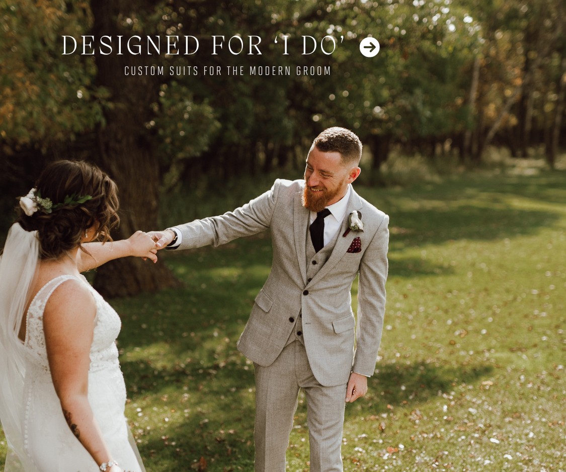 Groom in a tailored light gray wedding suit, holding the bride's hand, smiling outdoors with the caption 'Designed for I Do – Wedding Suits, Tailored for You'